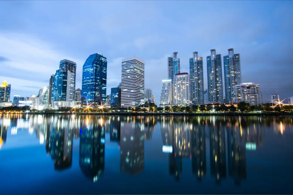 Bangkok skyline reflected in a park lake at dusk
